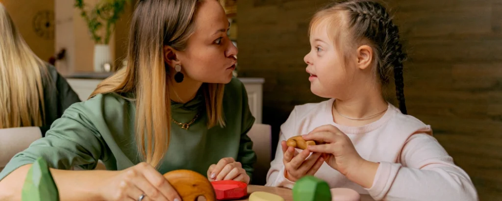 Support worker talking with disabled girl