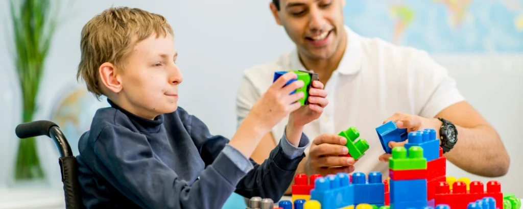 Disabled boy in wheelchair with lego