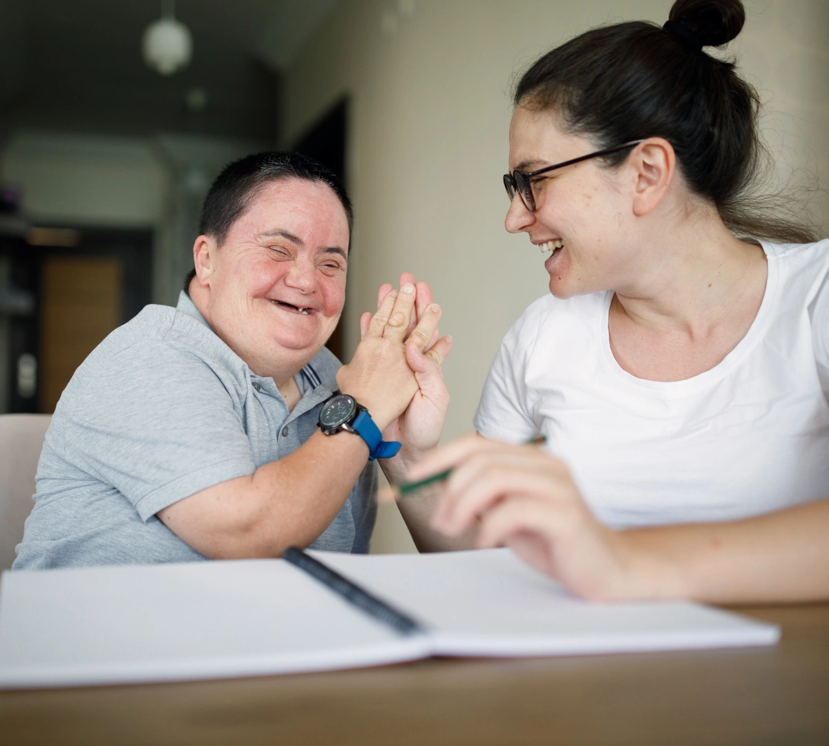 Support worker laughing with disabled woman