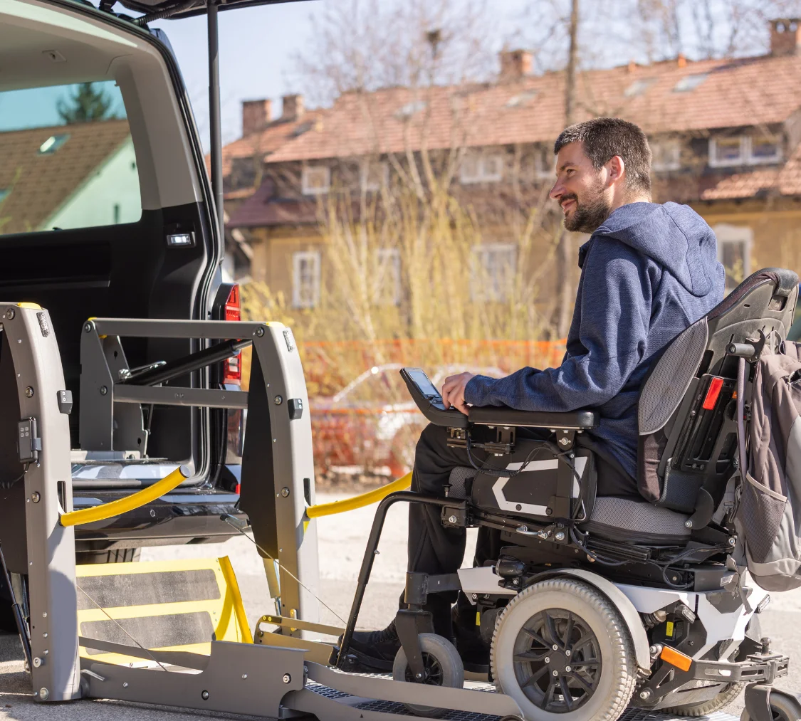 Disabled man in wheelchair getting into van