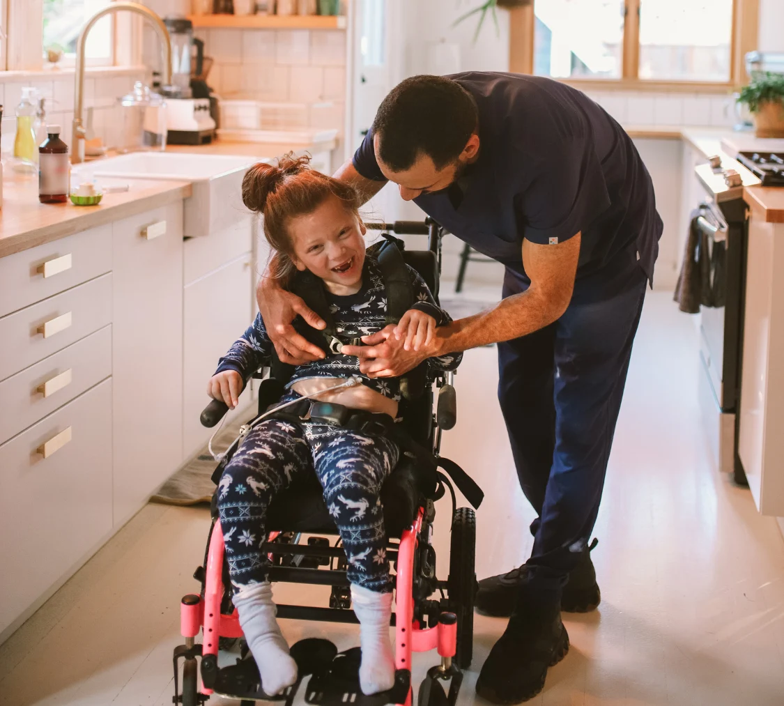 Disabled girl in wheelchair with support worker
